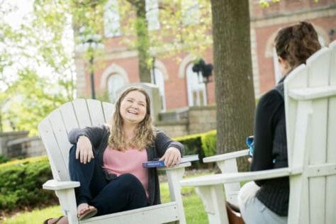 Students in the Adirondack chairs on campus outside of Old Main during the Creosote Affects photo shoot May 1, 2019 at Washington & Jefferson College.